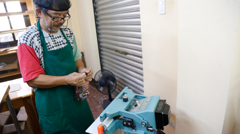 Ola farm employee packaging the processed coffee powder