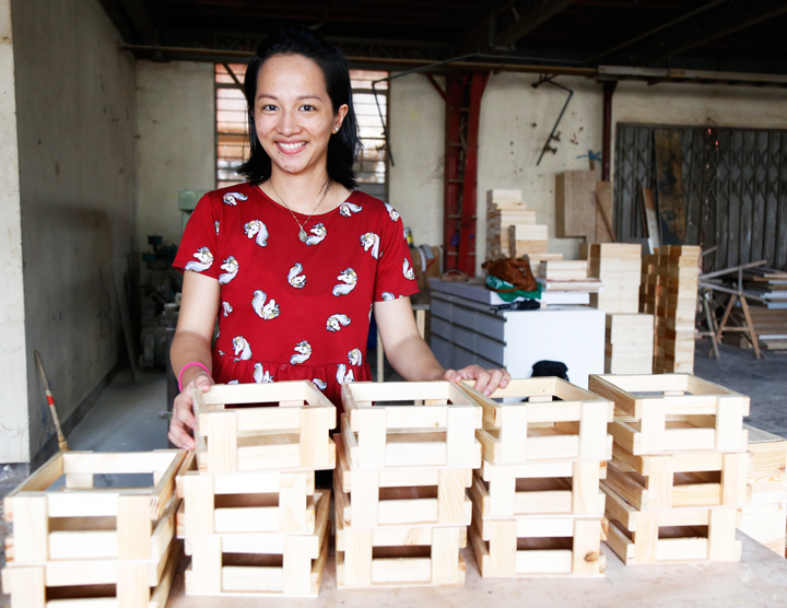 Rei Tugade posing with some of Balai Kamay's products, gift boxes.