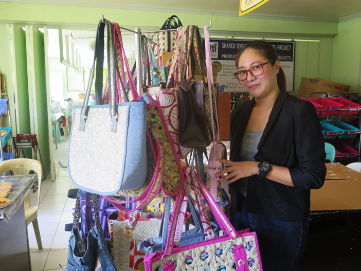 Kilusang Kabalikat ng mga may Kapansanan para sa Kinabukasan President May Camili poses with the bags created by the members of 4K, who are mostly Persons with Disabilities