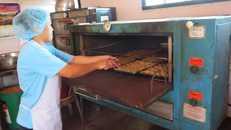 AN AWRIC member putting the peanuts in the oven