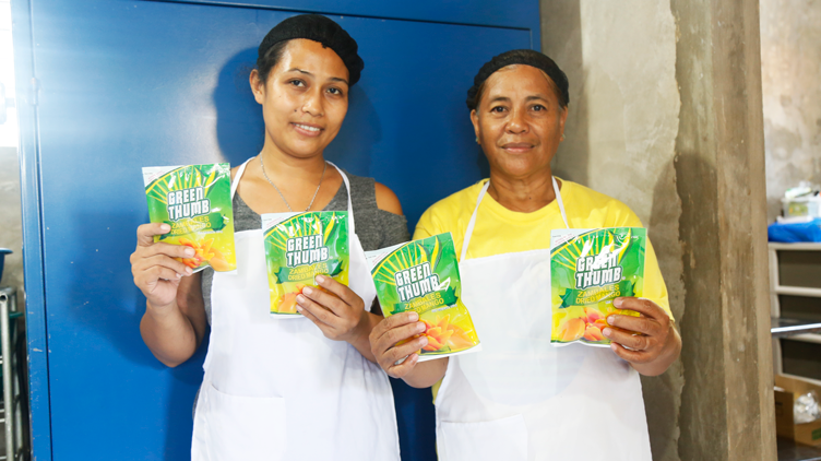 Evelyn Grace and an employee posing with their products