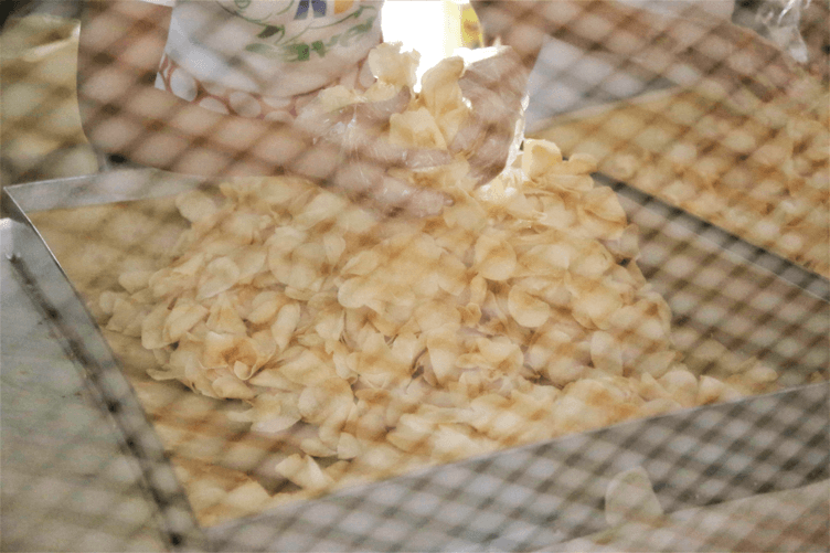 A Baker's Field employee processing biscocho