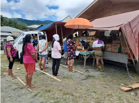 people lined up to buy goods