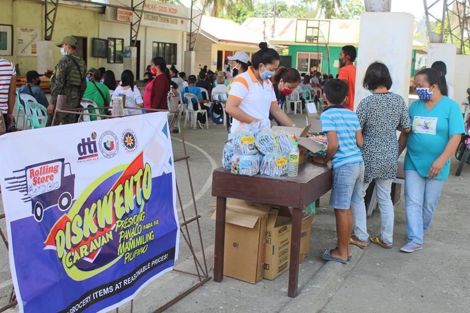 People line up to buy discounted products at the Diskwento Caravan rolling store