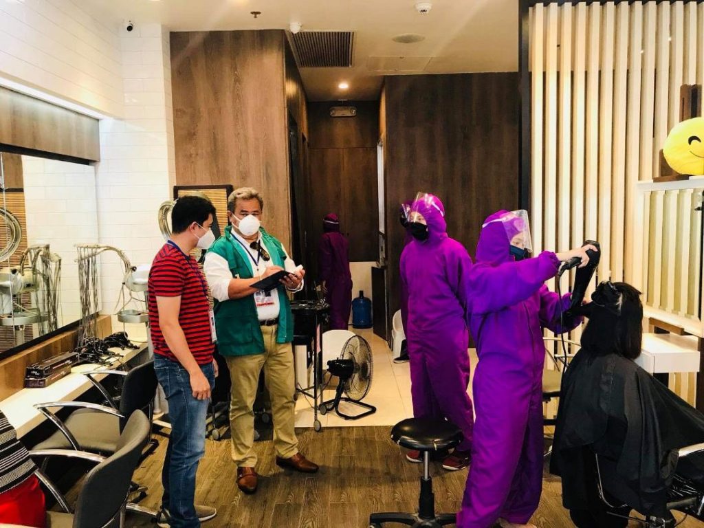 DTI inspectors observing salon employees in PPEs service clients in a salon in a mall in Region 9