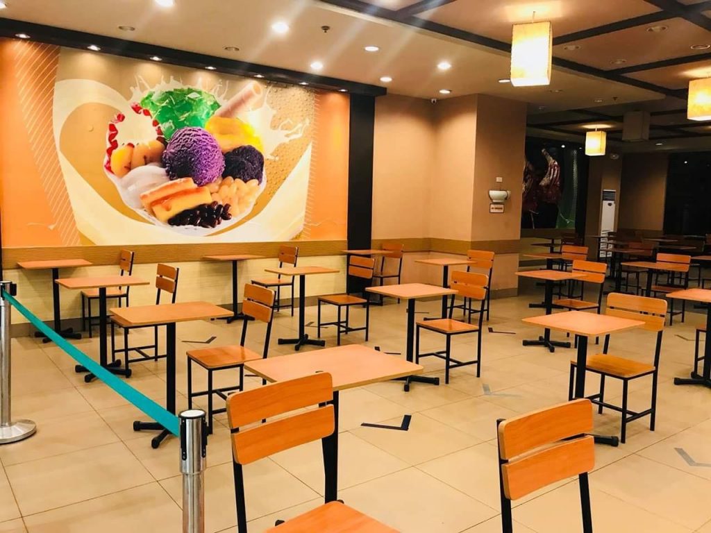 Tables and chairs placed at a safe social distance in a restaurant in a mall in Region 9