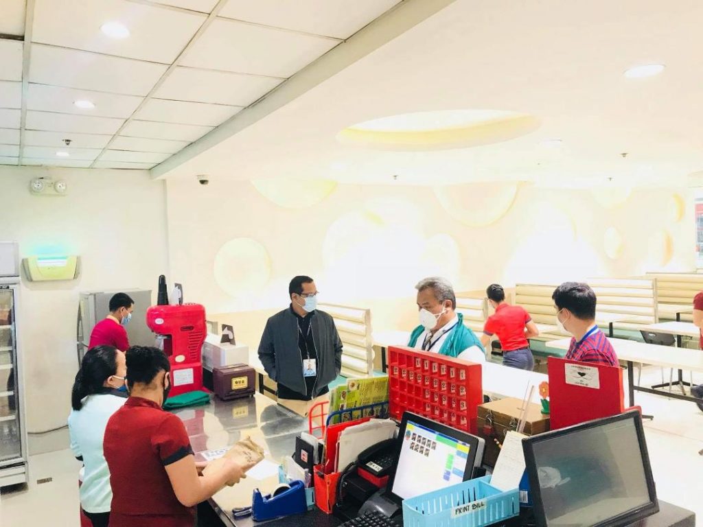 DTI inspectors and restaurant service crew wearing masks in a restaurant in a mall in Region 9
