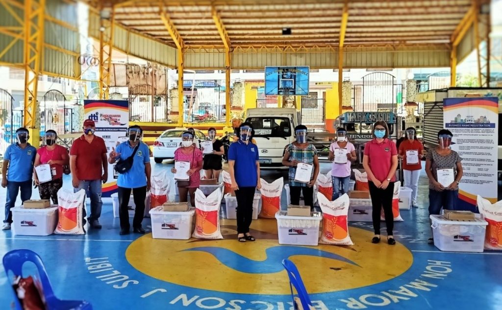 The beneficiaries of the Pangkabuhayan sa Pagbangon at Ginhawa (PBG) program with their livelihood kits.