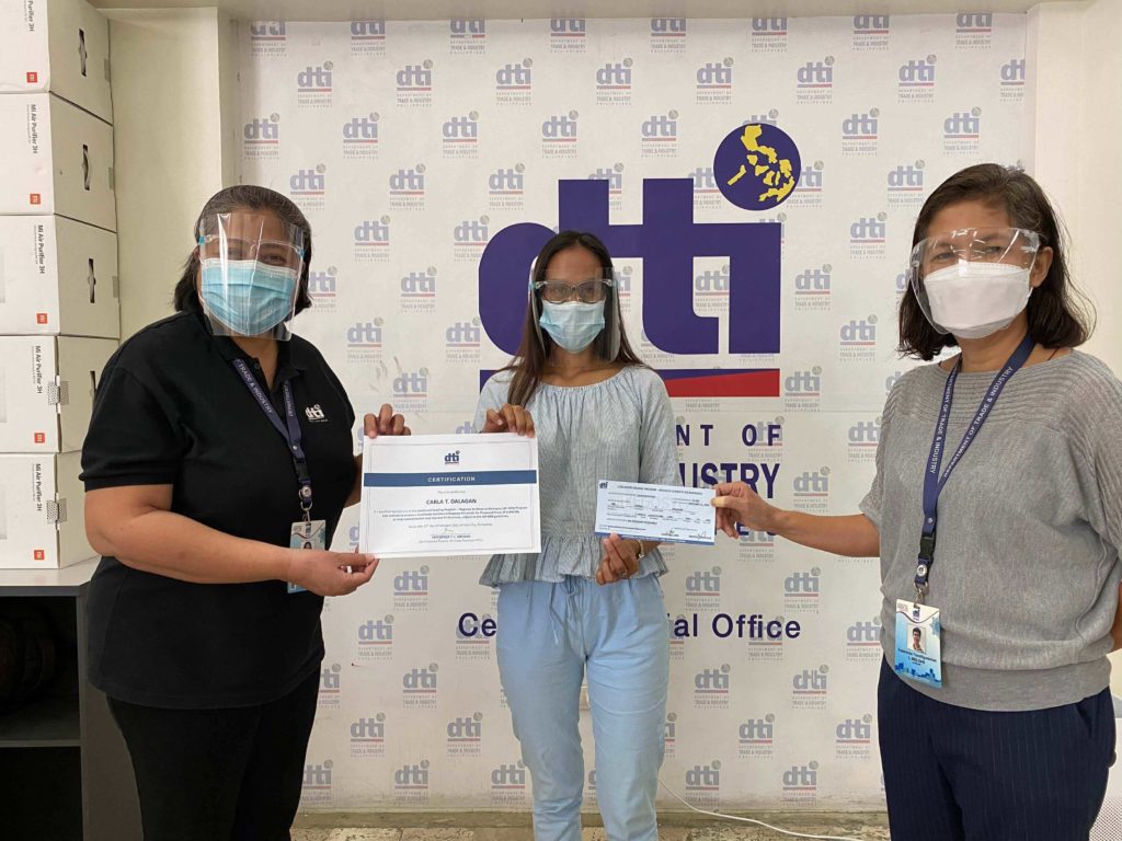 Ms. Carla Dalagan receives her certificate upon completion of the training program