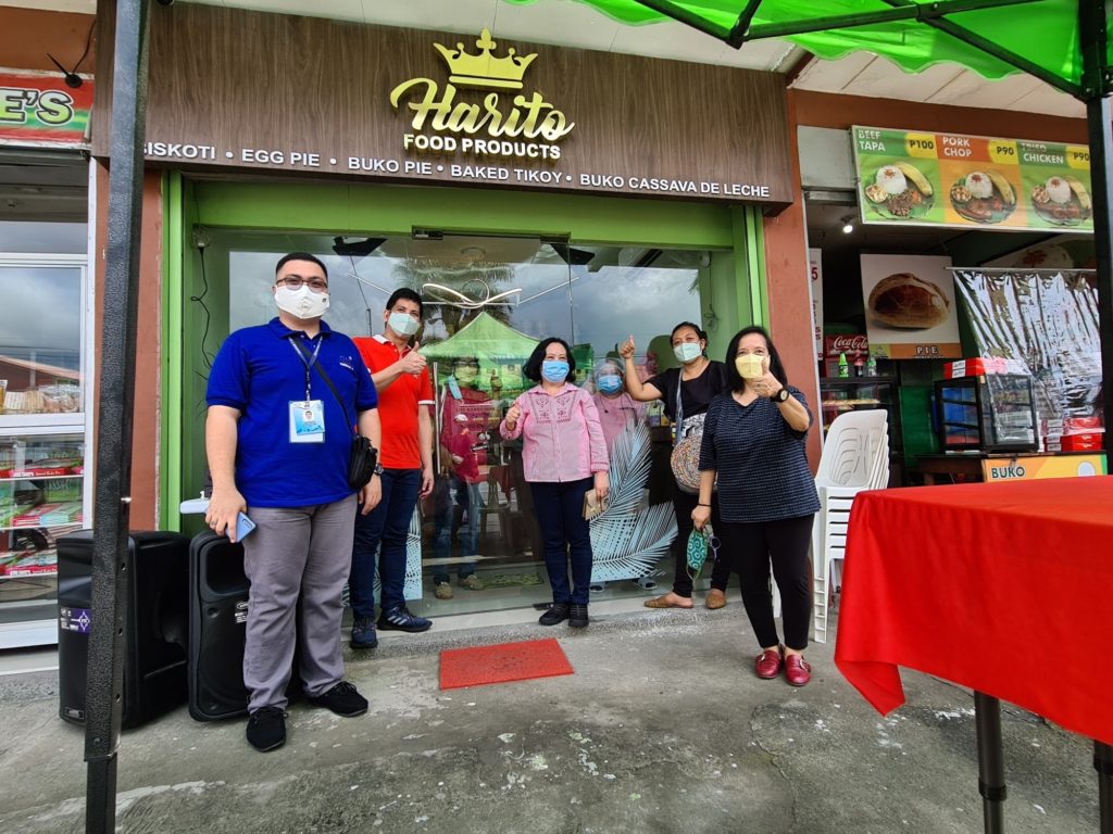 Men and women standing in front of Harito Food Products store