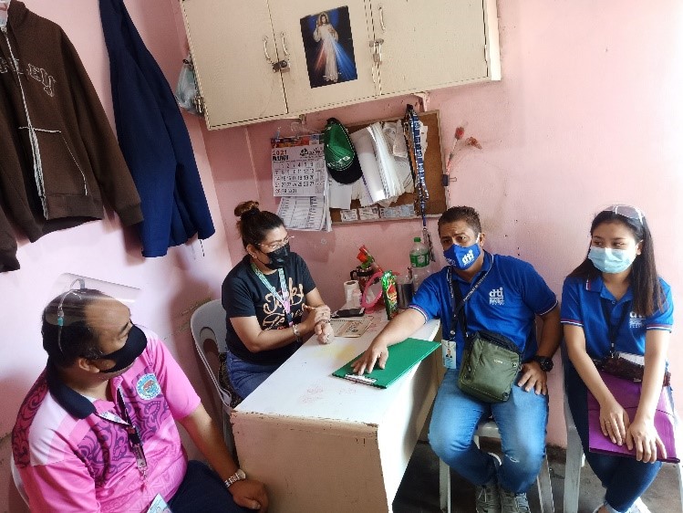 Representatives from DTI and Nagcarlan LGU discussing the results of the conduct of their inspection of business establishments at the temporary public market