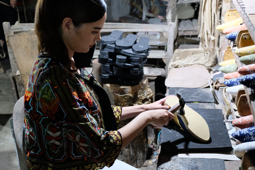 Catriona Gray bonding shoe sole by a small hammer