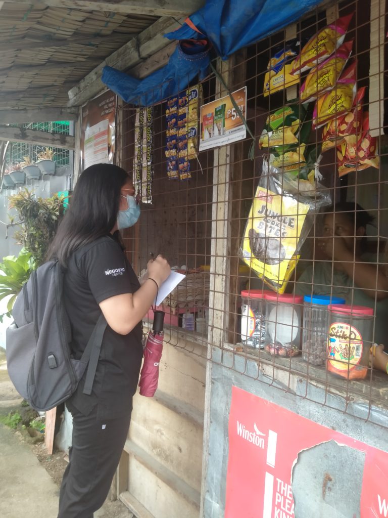 in photo: NC Polillo personnel conducting an inspection in a sari-sari store