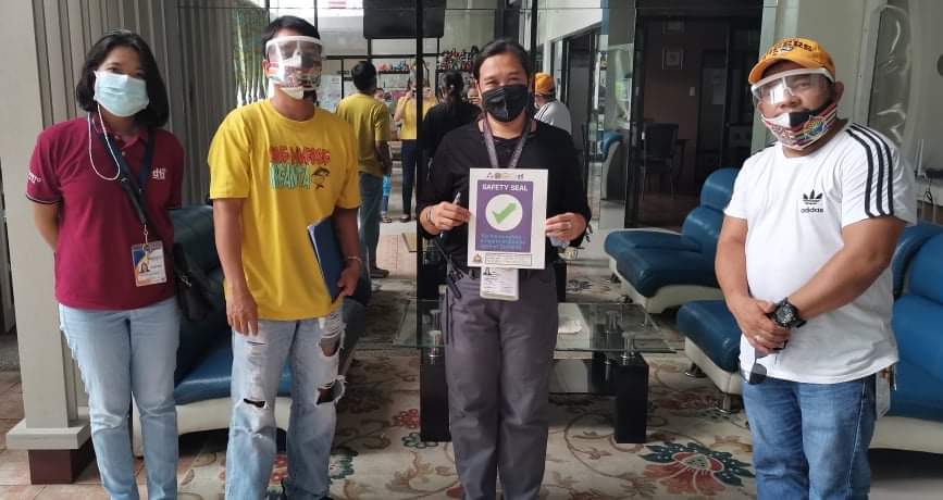 in photo: DTI Quezon team holding a safety seal certificate