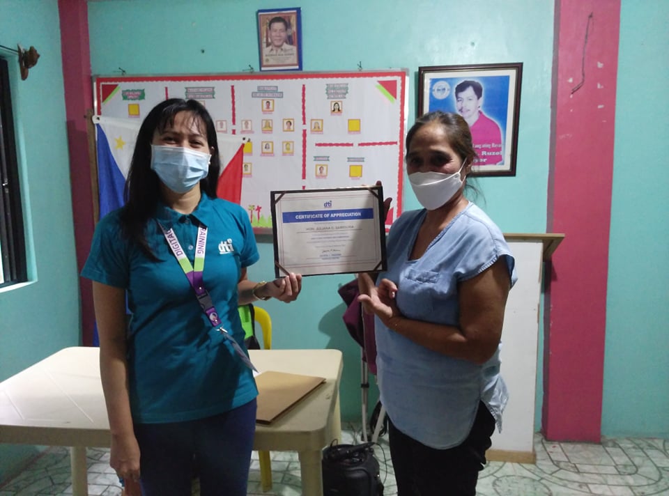in photo: Negosyo Center-General Nakar Business Counselor with a training participant holding a certificate