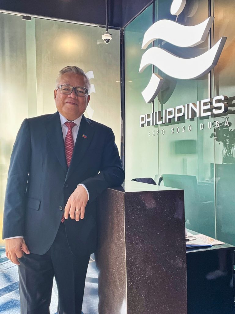 Secretary Ramon M. Lopez posing at the Expo 2020 signage