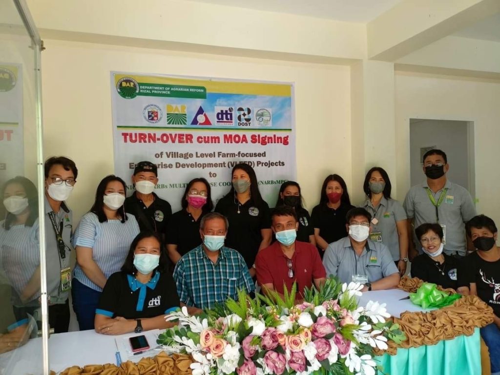 Group photo of the attendees of mushroom processing center turn over ceremony