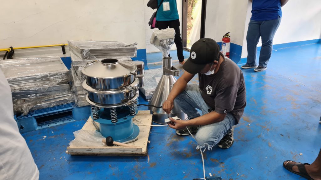 Personnel from Alabat Island Farmers Producers Cooperative inspecting the Coco Sap Sweetener machine