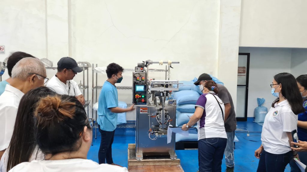 Personnel from Alabat Island Farmers Producers Cooperative and DTI SSF Quezon inspecting the Coco Sap Sweetener machine