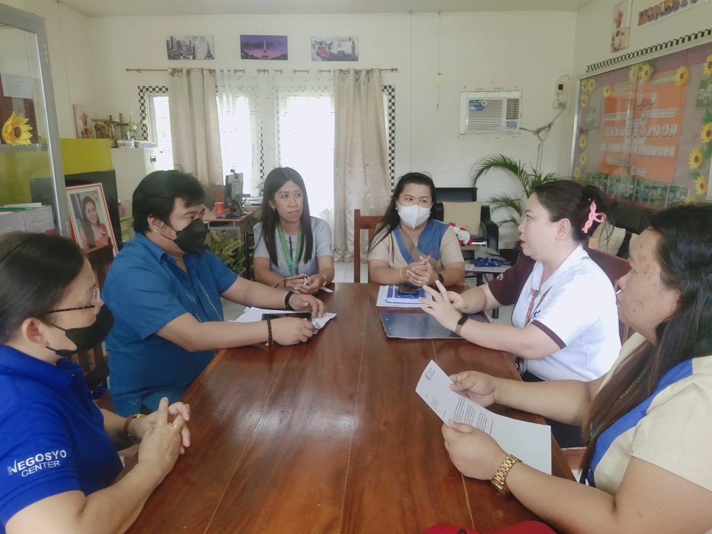 in photo: DTI Quezon represented by STIDS Ma. Graciela Ledesma, Negosyo Center Sariaya Senior Business Counselor Shayne B. Nocus, Sariaya Fiber Producers Association (SAFIPA) President Mr. Juan Espinosa, Pili National High School (PNHS) Principal I, Ms. Maribel Alcantara, and Technology and Livelihood Education (TLE) subject Teachers Ms. Katherine Joy Maaliw, Ms.Gemmalyn Beremer, and Mr. William June Rocero, discussing the possible partnership between the Buntal Processing Center and Pili National High School.