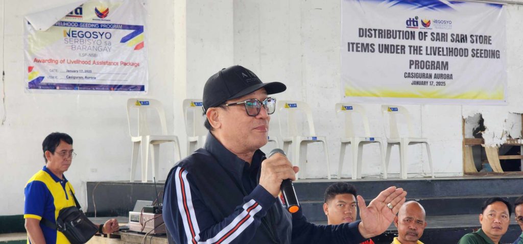 Asec. Dominic Tolentino giving a speech to beneficiaries of livelihood packages.