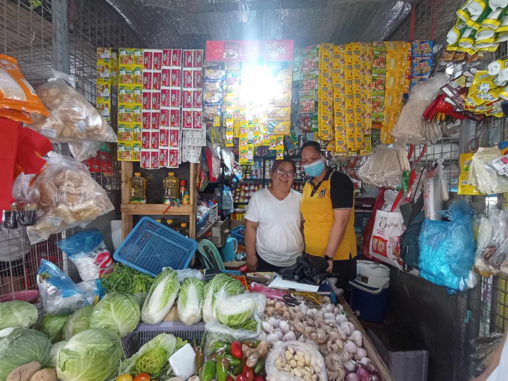 Owner or Cathys Variety Store posing for a photo with the DTI Region 4A personnel.