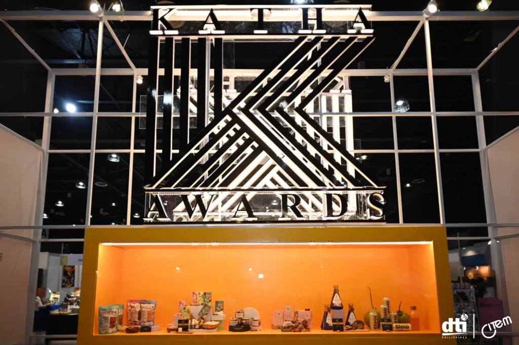 KATHA Awards display at IFEX Philippines, featuring an illuminated sign and a showcase of food product nominees and winners. The exhibition highlights excellence and innovation in the Philippine food industry, with the DTI Philippines and CITEM logos visible.