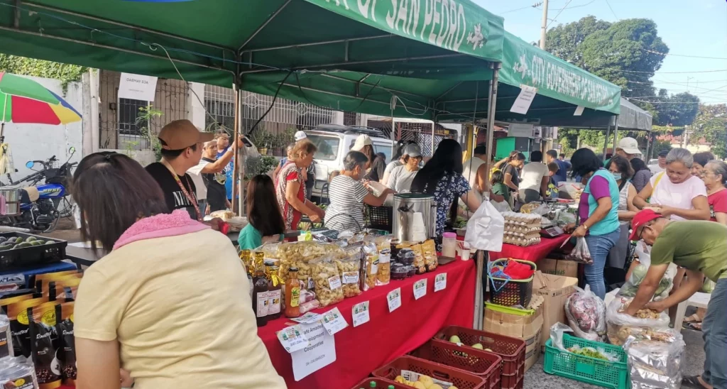 In photo: Shoppers browsing local products at a Kadiwa ng Pangulo stall in San Pedro City, Laguna.