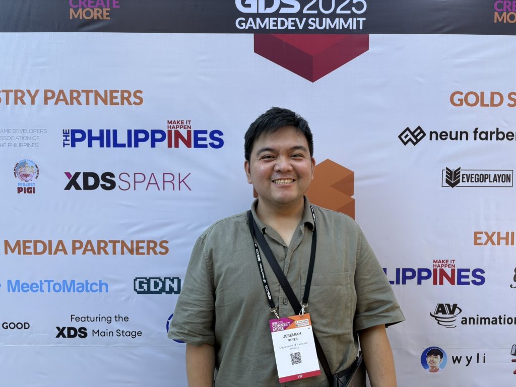 The DTI-FTSC representative at the 2025 GameDev Summit, Foreign Trade Service Officer Jeremiah Reyes posing in front of a photo wall