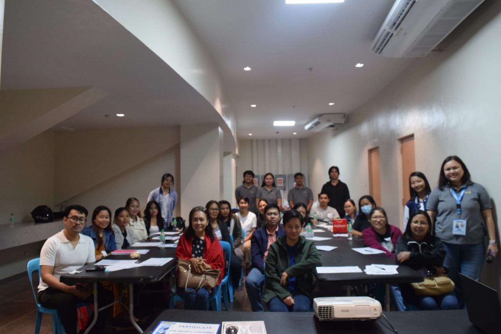 Group photo of DTI-Laguna pricing & costing seminar participants in a bright, indoor setting.