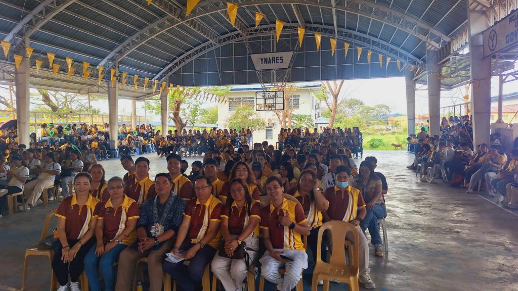 Faculty, staff, and students of the University of Rizal System Pililla Campus College of Business seated alongside DTI 4-A Rizal’s Jerome Montealegre in a covered court during the 2025 College of Business Week celebration.