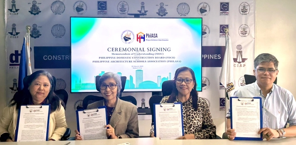 Four representatives from the Philippine Domestic Construction Board (PDCB) and the Philippine Architecture Schools Association (PHILASA) holding signed MOU documents in front of a ceremonial signing backdrop. From left to right: Engr. Jocelyn Carrasco, Doris U. Gacho, Ar. Jean Cornejo, and Ar. Sylvester Seno.