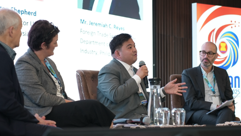 Foreign Trade Service Officer Jeremiah C. Reyes speaks into a microphone while seated alongside other panelists during a discussion on a regional approach to the creative economy.