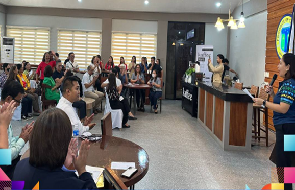 Conference with attendees applauding as a speaker presents at the DTI OTOP store opening in Cagayan Valley.