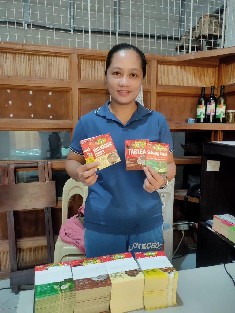 Ms. Rosemarie Guzman posing with her products.