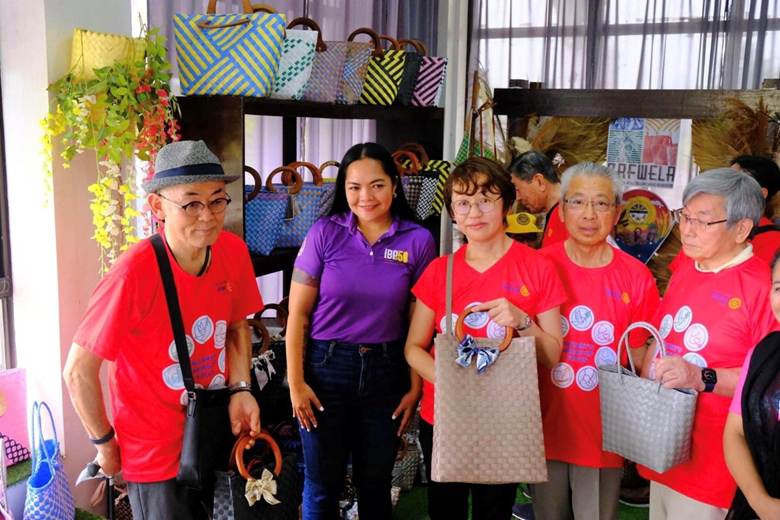 A group of weavers from Davao del Norte proudly showcasing their banana fiber bayong bags.