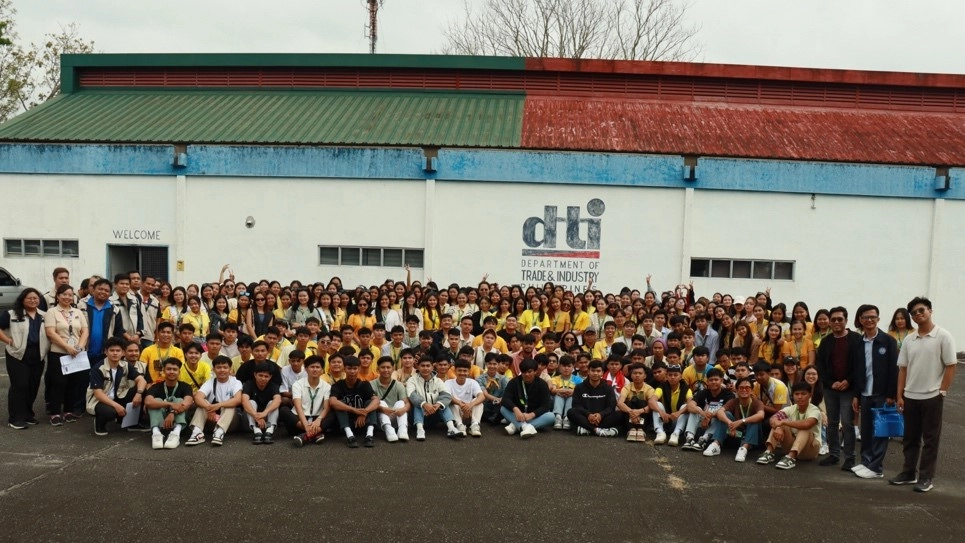 A large group of University of Northern Philippines (UNP) students pose for a photo outside a Department of Trade and Industry (DTI) building during their educational tour in Cavite, which focused on standards and product testing.