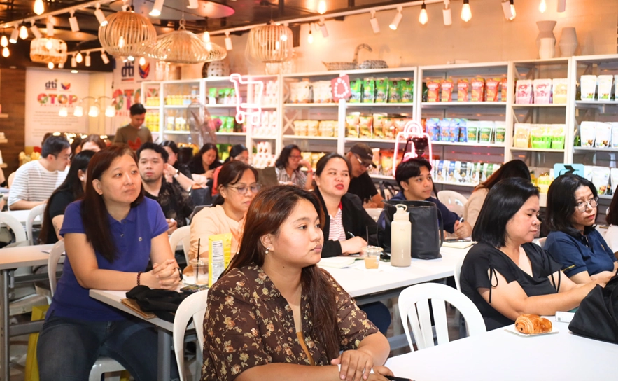 A group of people attending a meeting or presentation in a retail setting.