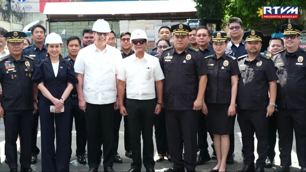 President Ferdinand R. Marcos Jr. (center, white shirt, sunglasses, hard hat) stands with DTI Secretary Cristina Roque (dark suit, left), DOF Secretary Ralph Recto (white shirt, hard hat, next to President), BOC Commissioner Bienvenido Rubio (uniform, center-right), and other officials for a group photo at the Port of Manila during the vape condemnation event on April 7.