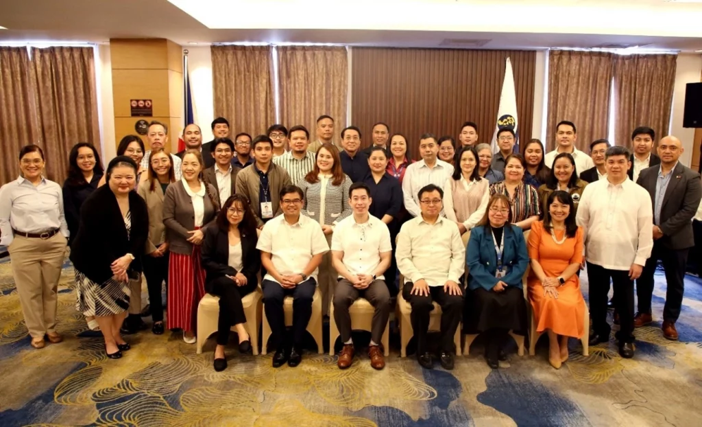 Representatives from key government agencies pose together for a formal group photo during the Tatak Pinoy Council 1st Joint Working Group Meeting, held in a conference room setting.