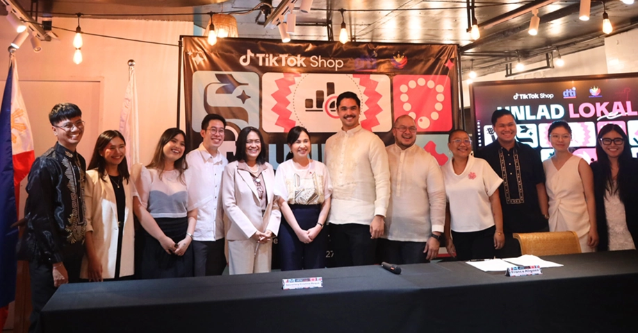 Group photo of people standing in front of a TikTok Shop banner.