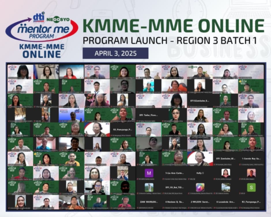 A screenshot shows a virtual meeting with numerous participants in a grid layout. The meeting is titled "KMME-MME ONLINE PROGRAM LAUNCH - REGION 3 BATCH 1" and the date "APRIL 3, 2025" is visible at the top. The "dti Negosyo Mentor Me Program" logo is in the upper left corner. Many participants have their video feeds active, displaying individuals in various settings. Some participants have their names or initials displayed on their video tiles. The overall impression is of a large online event or webinar.