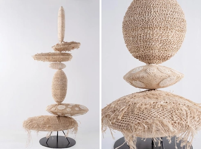 Untitled sculptural piece by Milo Naval in collaboration with Shelmed Cottage Treasures, featuring a vertical arrangement of raw seashells and abaca. The artwork includes a large spherical form at the top and several textured disc-like shapes below, all mounted on a black stand, symbolizing heritage, strength, and transformation.