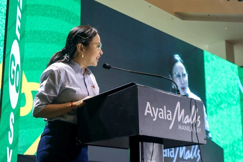DTI Secretary Cristina A. Roque delivers a speech at the Creative Entrepreneurship Summit 2025 held at Ayala Malls Manila Bay, with a backdrop displaying the Go Negosyo branding. DTI Secretary Cristina A. Roque delivers a speech at the Creative Entrepreneurship Summit 2025 held at Ayala Malls Manila Bay, with a backdrop displaying the Go Negosyo branding.
