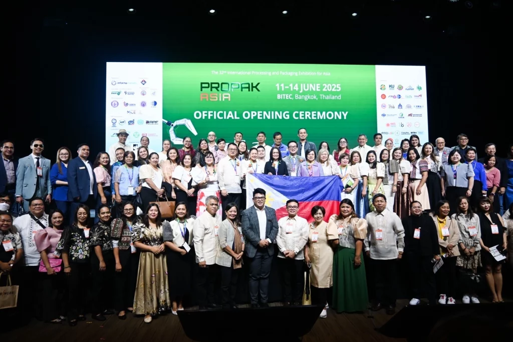 Group photo of delegates and officials during the opening ceremony of ProPak Asia 2025 at BITEC, Bangkok, featuring the event backdrop and sponsor logos, with some participants holding a flag in the front row.