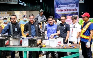 DTI officials and workers gather around confiscated automotive batteries during the ceremonial destruction event held at a waste disposal facility in Valenzuela City. The activity, led by the Fair Trade Enforcement Bureau, highlights the agency’s commitment to consumer protection and product safety enforcement.