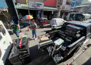DTI officials inspecting confiscated vape products during a crackdown near schools, enforcing Republic Act No. 11900