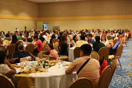A large conference room filled with round tables and numerous attendees, likely BPLOs from Central Luzon, engaged in discussions during the 2025 Central Luzon Regional Convention in Tagaytay City. The setting reflects a formal and collaborative atmosphere aligned with the event’s focus on improving business services and local governance.