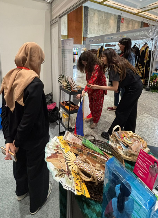 Visitors explore Zendease’s booth, featuring handcrafted trinkets and distinctive souvenirs from the Philippines. (Photo by Zendease)