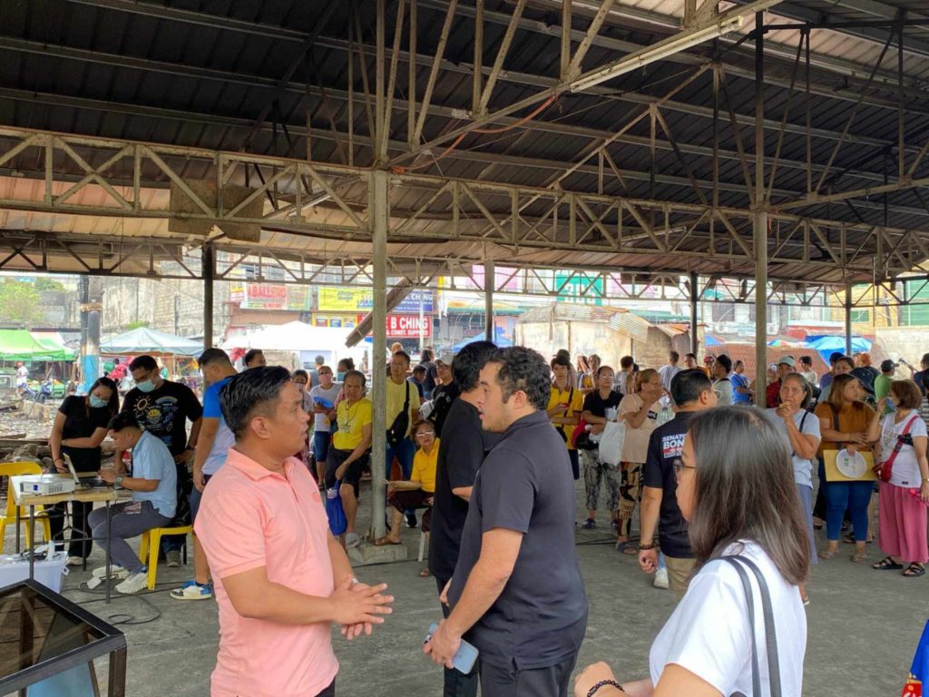 Government officials from Senator Bong Go’s office and DTI-Laguna provide relief assistance and introduce livelihood recovery programs to fire victims at Santa Cruz public market, highlighting the Pangkabuhayan sa Pagbangon at Ginhawa initiative and collaborative disaster response efforts.